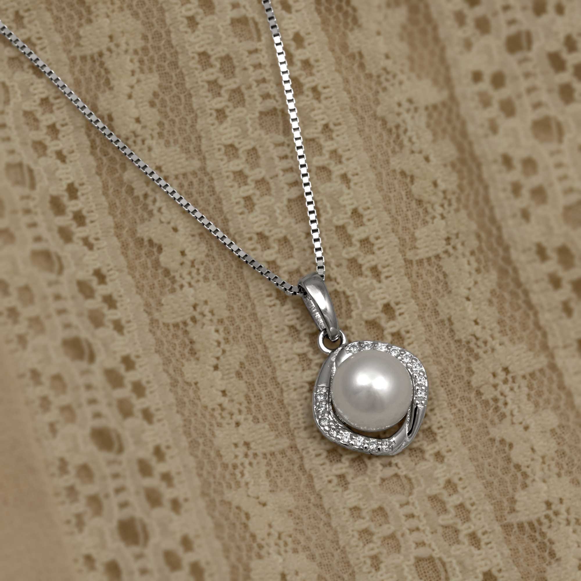 Silver necklace with a round freshwater pearl pendant, accented with cubic zirconia