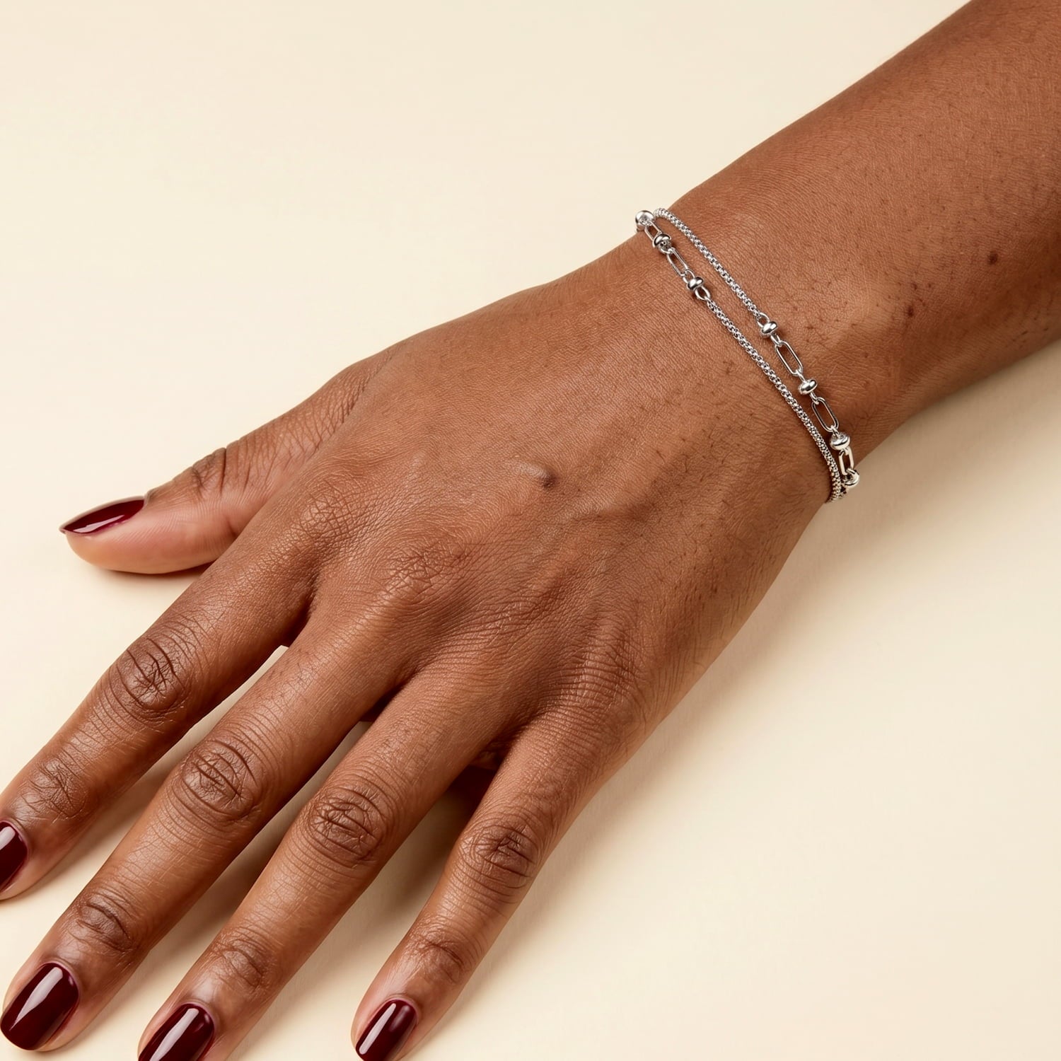 Sterling silver double popcorn chain bracelet with feature links worn on the wrist.