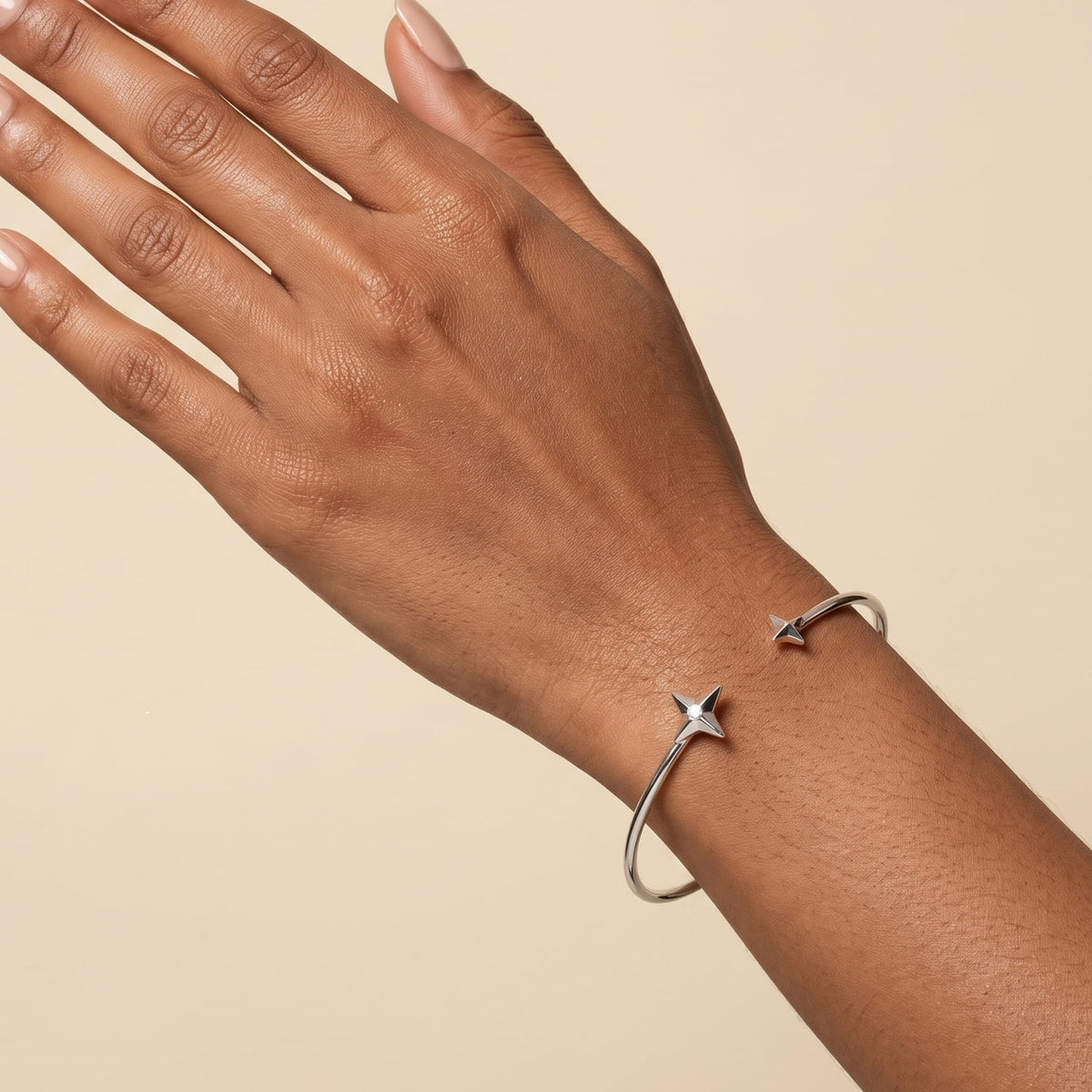 Model wears a sterling silver stars bangle with lab grown diamond