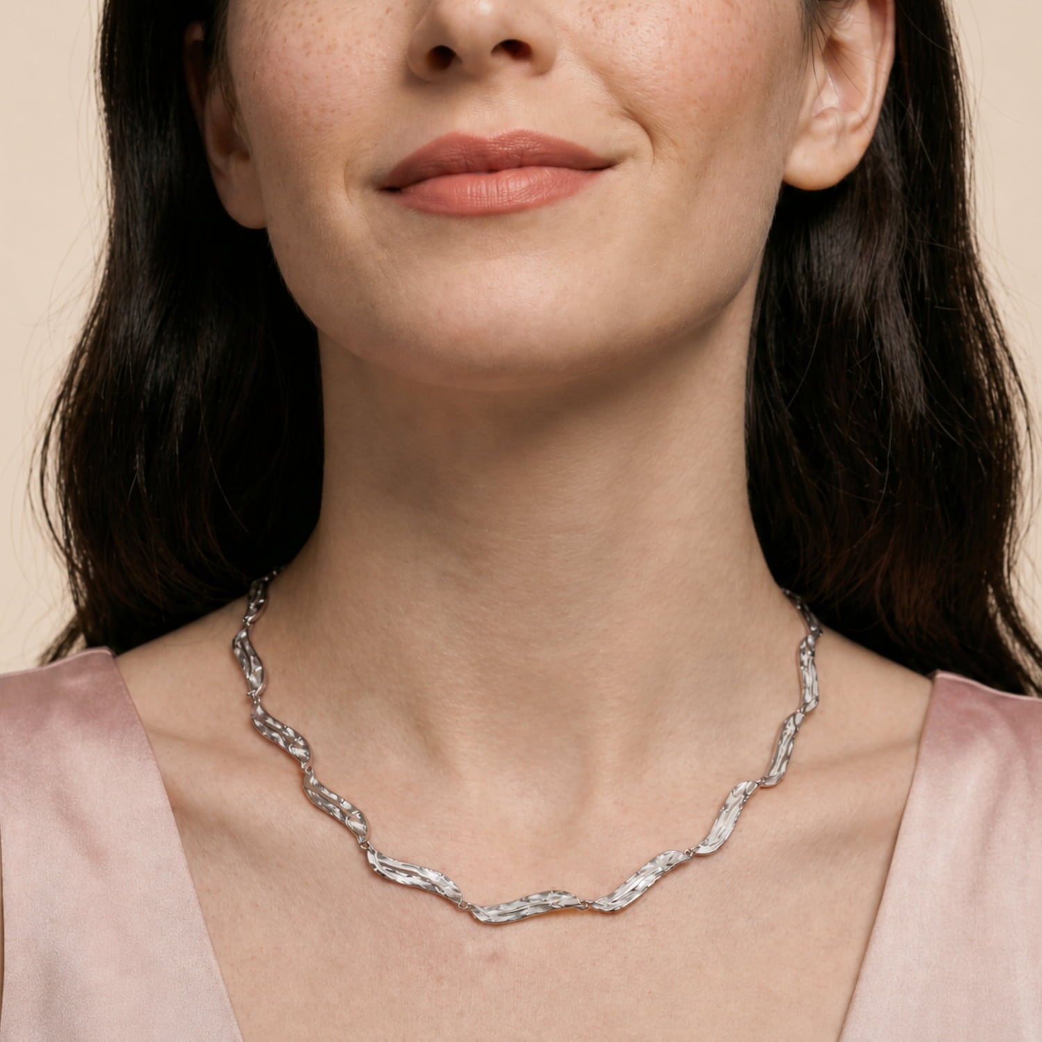 Sterling silver necklace featuring sculptural, irregular waterfall-inspired links with a polished finish, creating a modern and refined statement piece.
