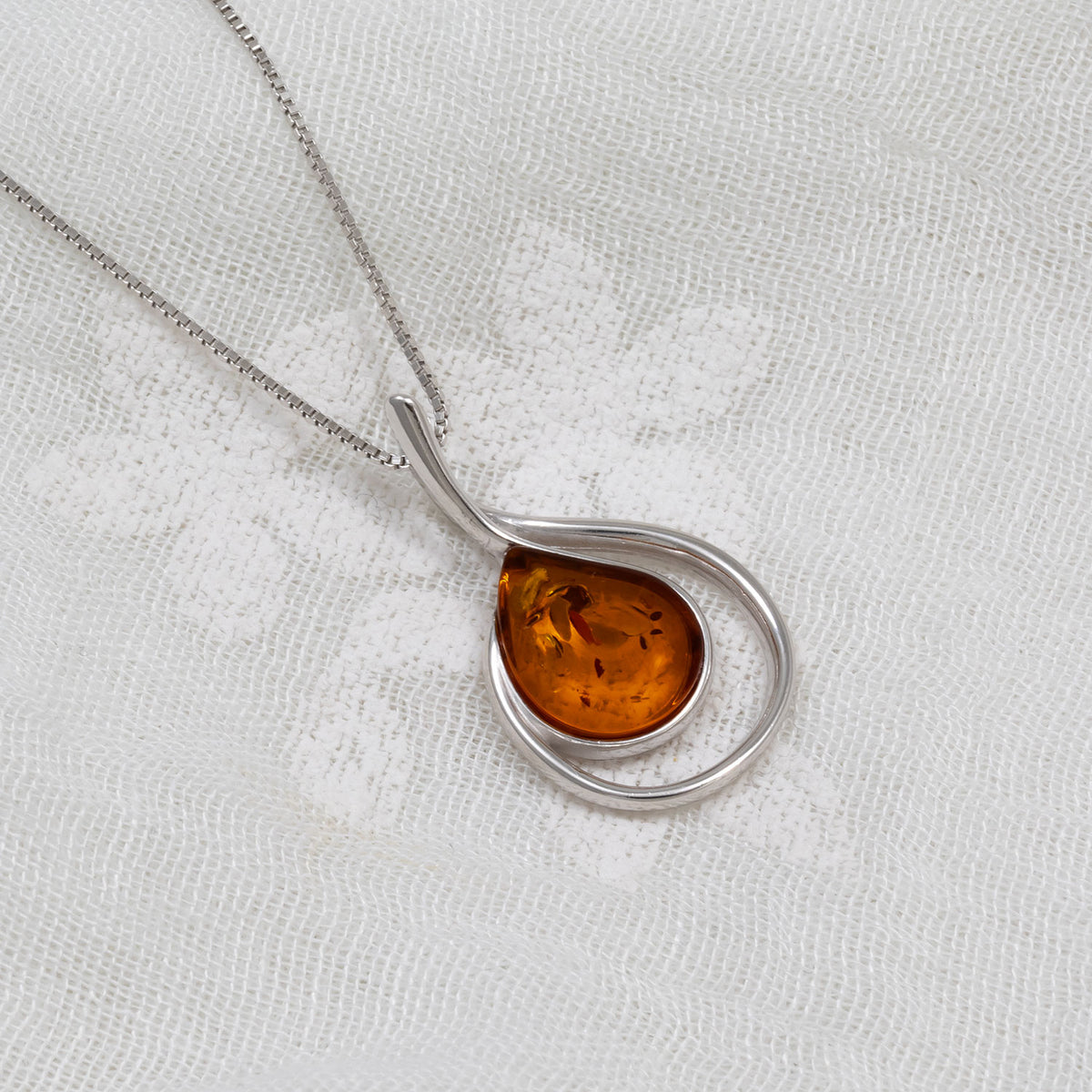 Silver Curling Teardrop Amber Pendant