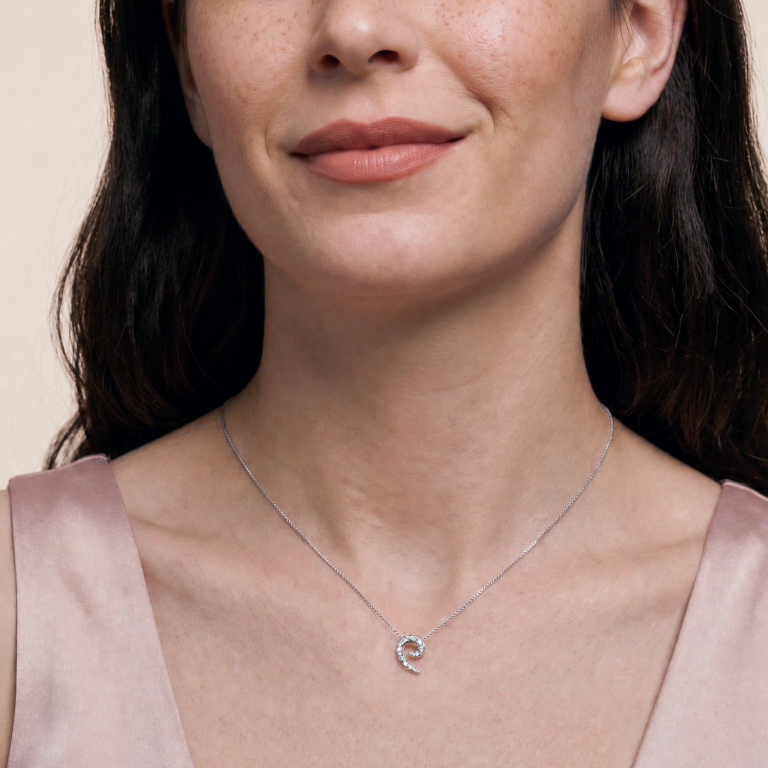 Sterling silver pendant with a textured curling horn design suspended on a delicate box chain, exemplifying sculptural elegance in contemporary silver jewellery.