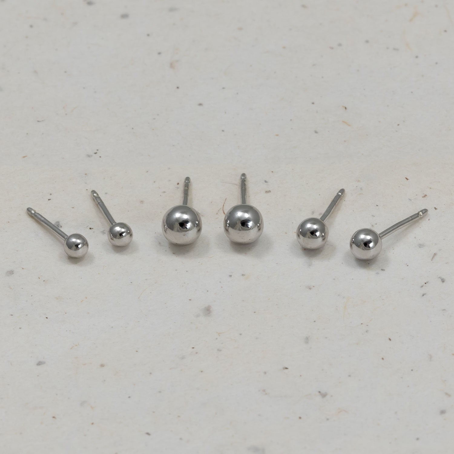 Set of sterling silver ball stud earrings in three graduated sizes, showcasing a polished and minimalist sphere design perfect for versatile everyday wear.