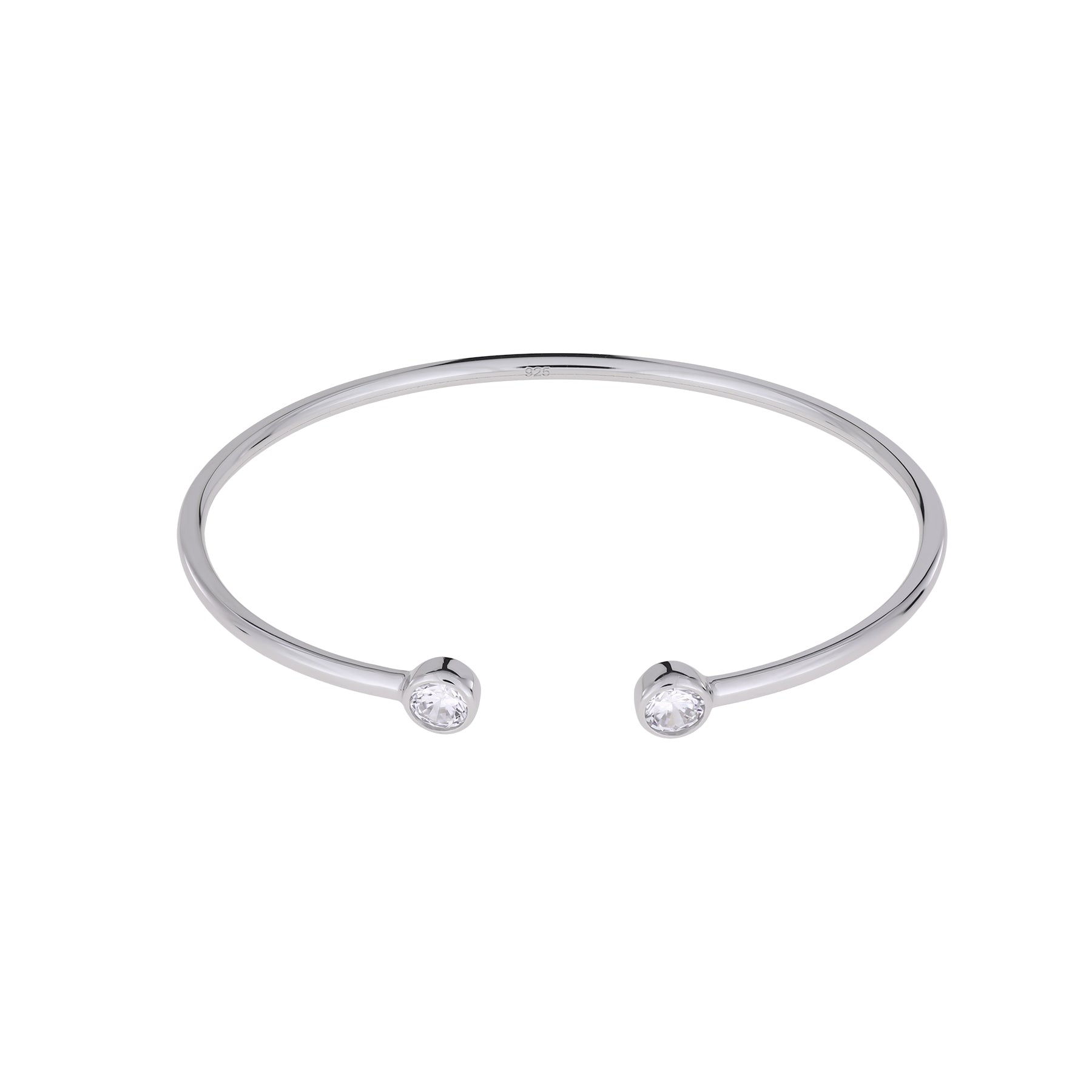 Minimalist sterling silver cuff bangle featuring open ends each set with sparkling cubic zirconia stones, exemplifying sleek contemporary British silver jewellery design.