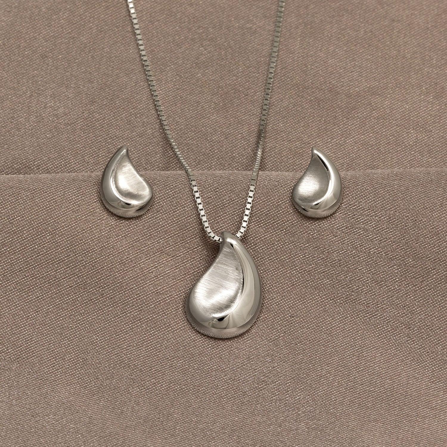 Pair of sterling silver teardrop stud earrings with a satin and polished finish, featuring a smooth, contemporary design that complements elegant everyday silver jewellery.