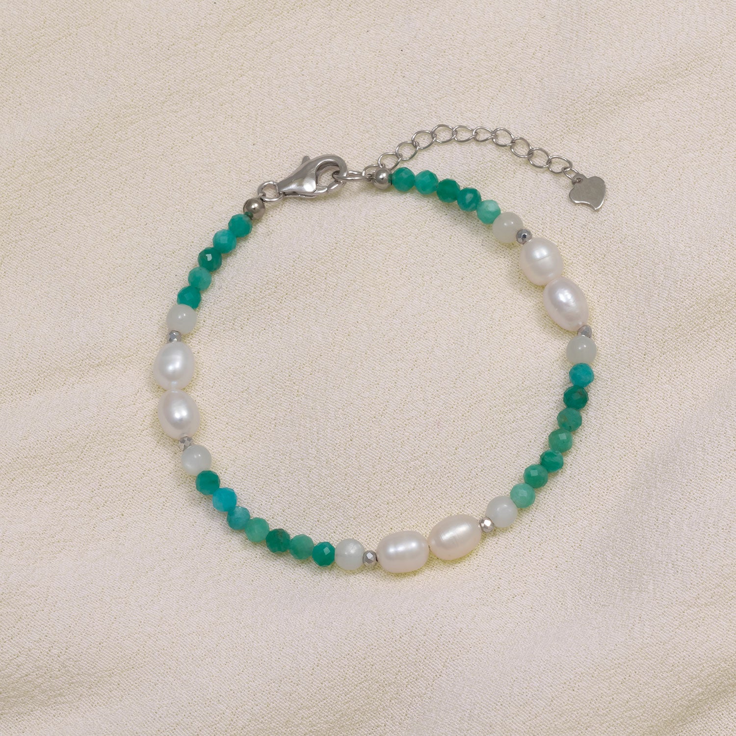 Adjustable sterling silver bracelet featuring smooth amazonite beads paired with lustrous freshwater pearls, combining natural hues with a refined designer finish.