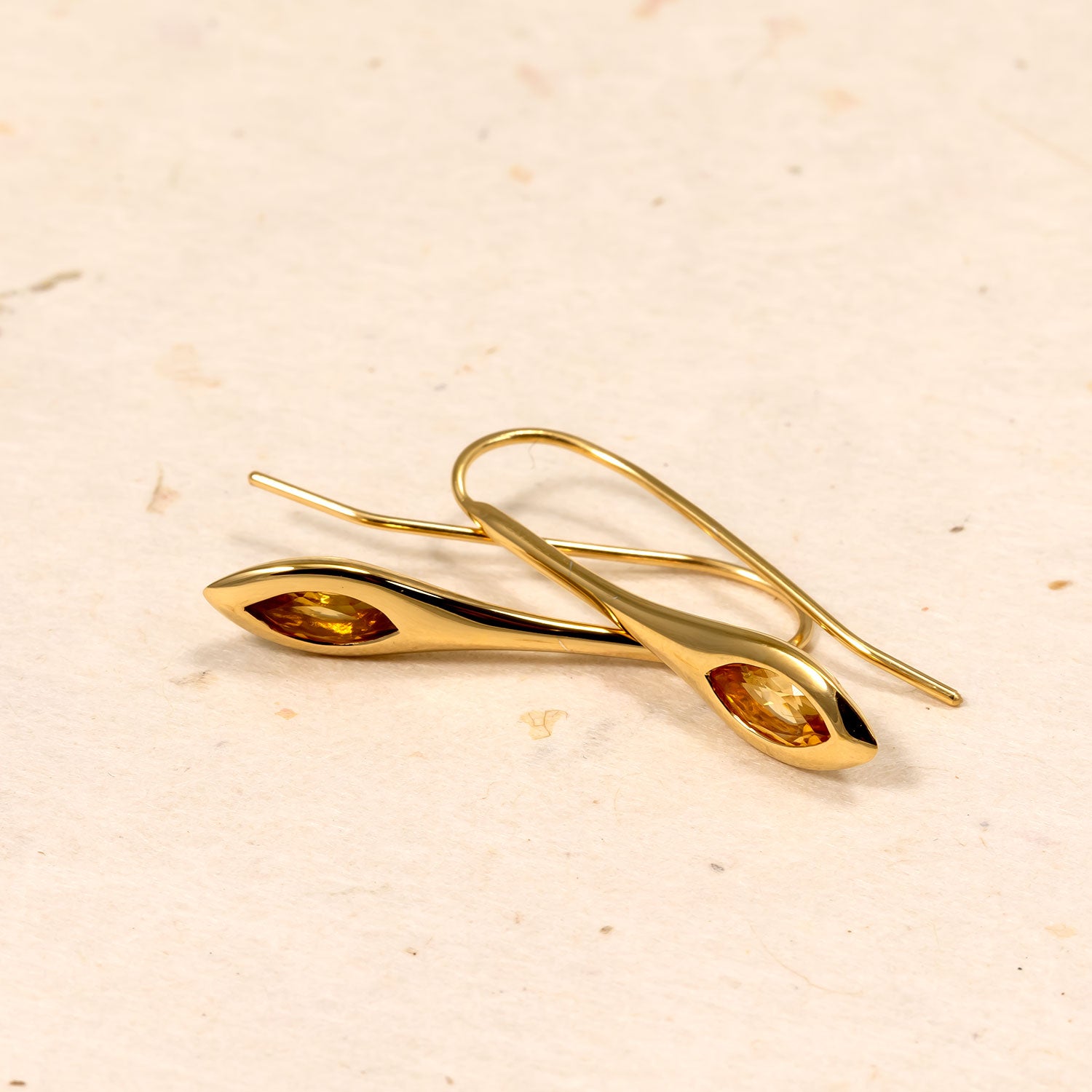 Pair of gold vermeil drop earrings featuring elegant marquise-shaped citrine gemstones set in polished, sculptural frames for a refined and contemporary silver jewellery look.