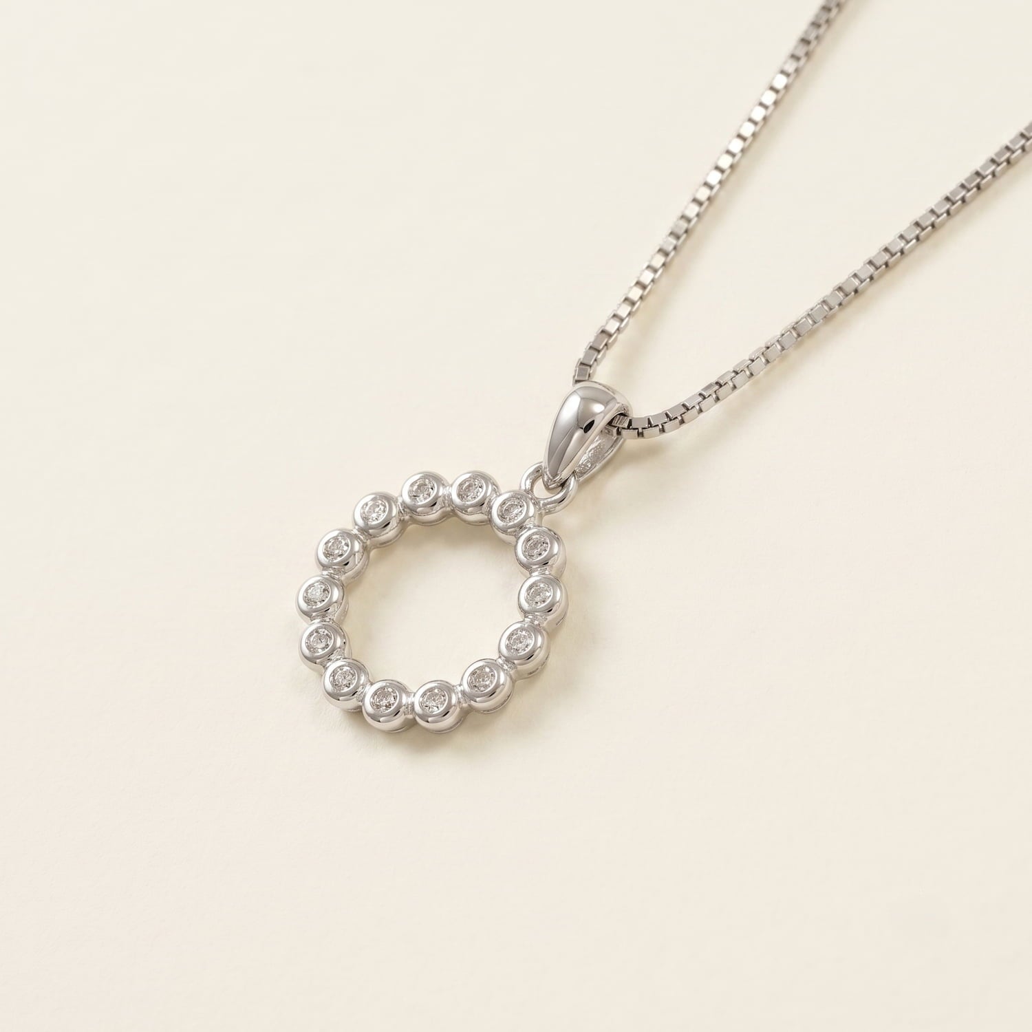 Sterling silver pendant featuring a full circle design set with sparkling cubic zirconia stones, suspended on a delicate fine chain for elegant everyday wear.