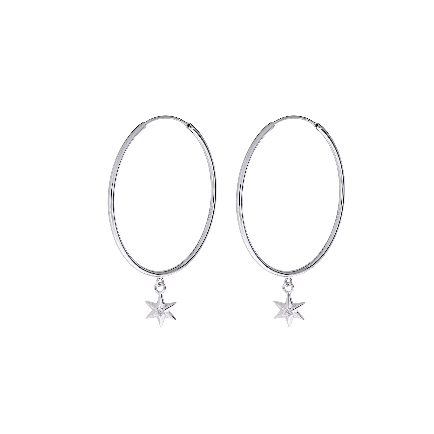 Slim sterling silver hoop earrings featuring delicate six-pointed star charms, combining minimalist elegance with a sculptural design in contemporary fine silver jewellery.