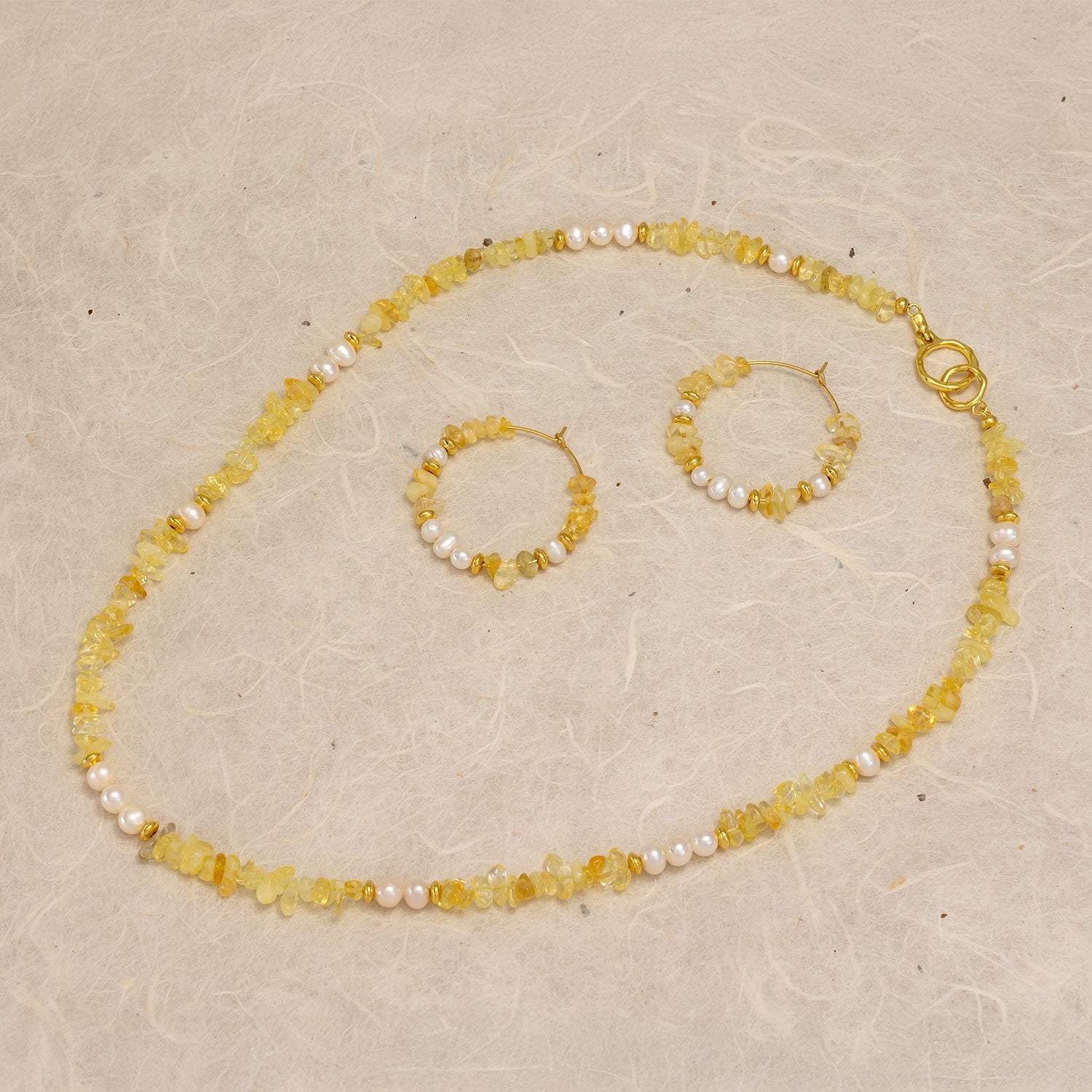 Delicate gold vermeil hoops and matching necklace featuring faceted citrine stones and freshwater pearls, showcasing elegant design in fine jewellery by Azendi.