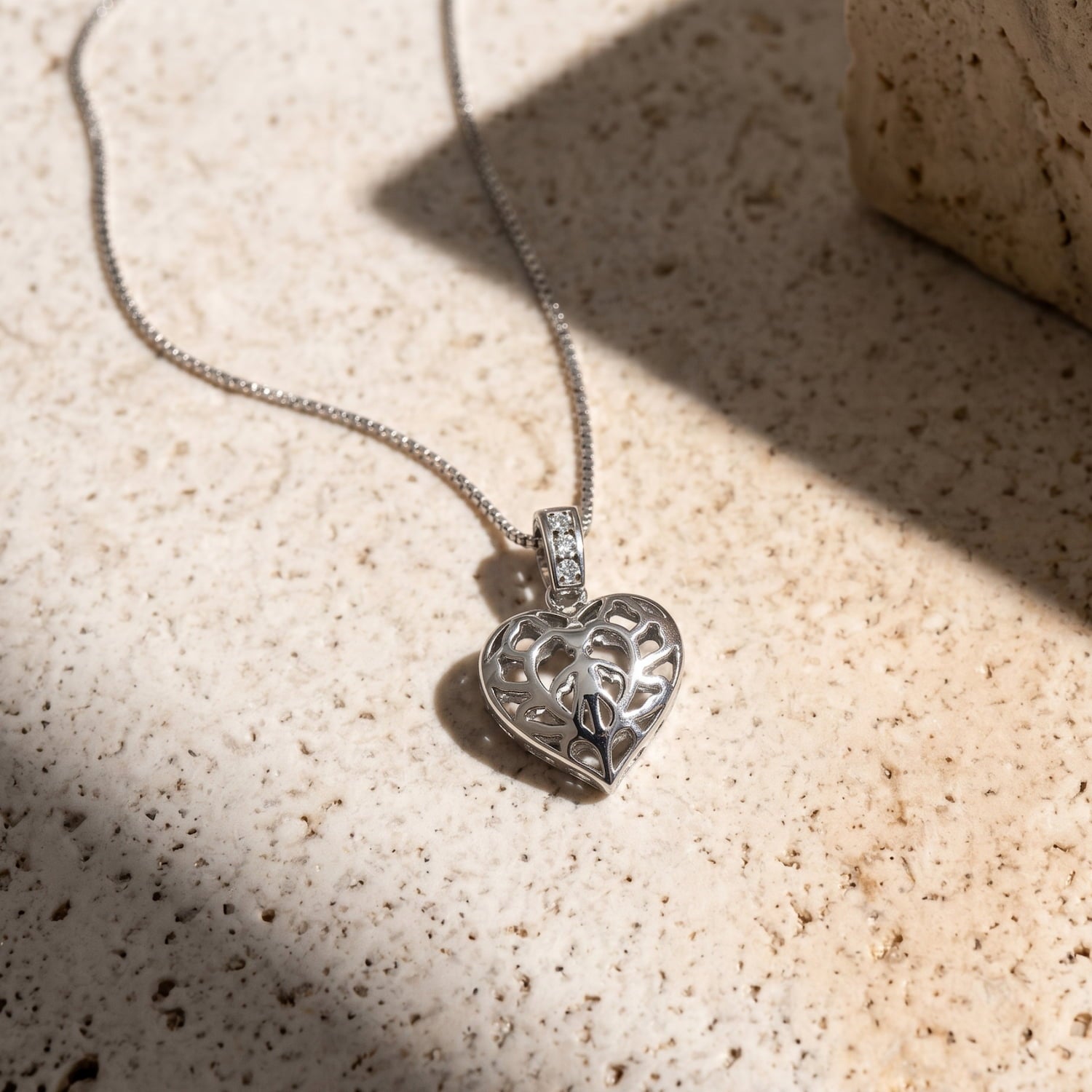 Lab grown diamond and sterling silver hanging heart pendant featuring delicate and intricate cut-out detailing, designed for elegant everyday wear.