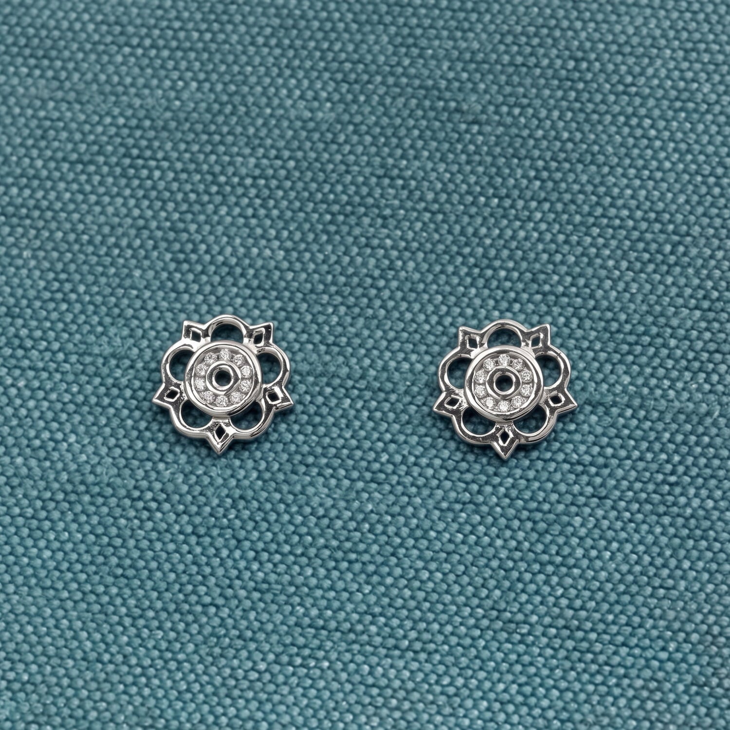 Pair of sterling silver stud earrings featuring a delicate cut-out Yorkshire rose design, combining fine detailing with a polished finish for refined contemporary silver jewellery.