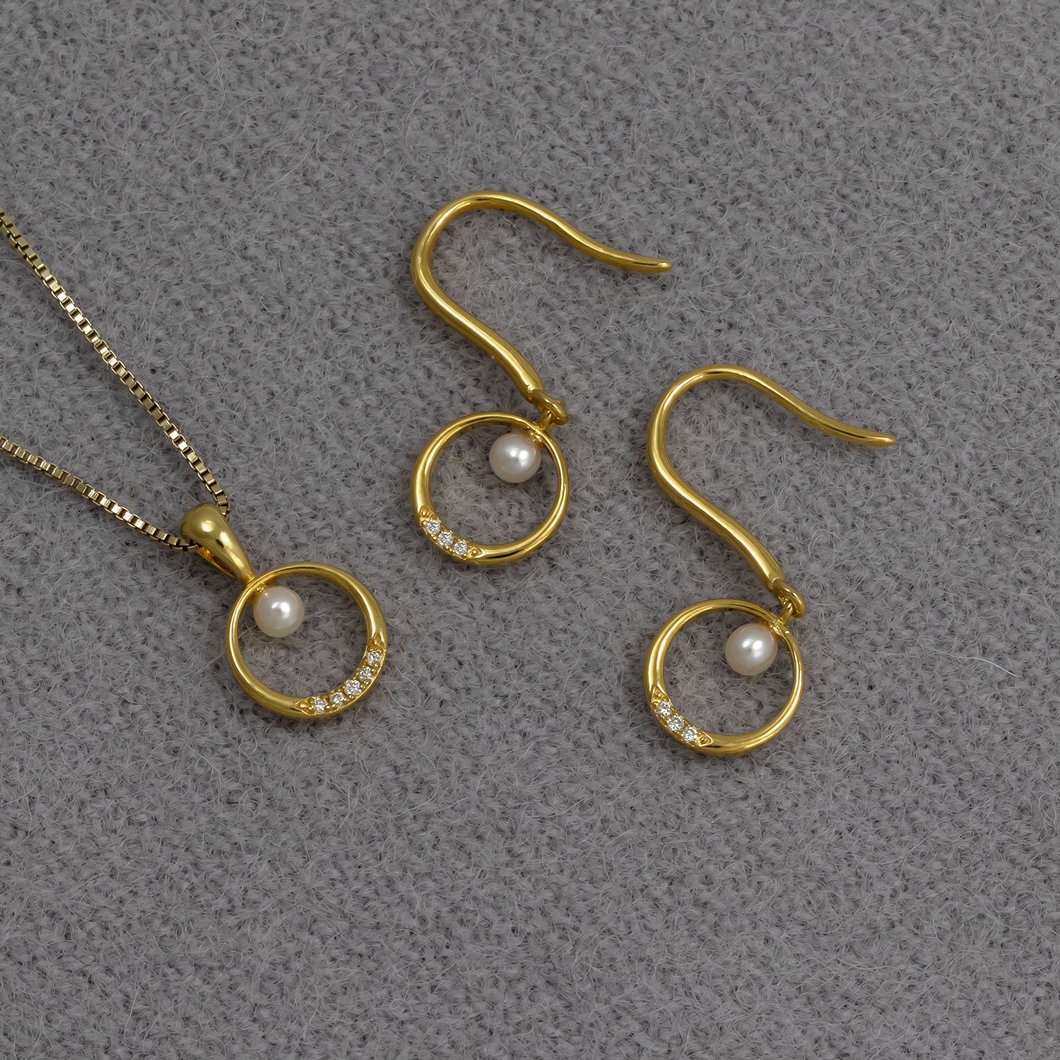 Gold vermeil drop earrings featuring circular pendants adorned with a freshwater pearl and a row of small lab-grown diamonds, paired with a matching pendant on a fine chain.