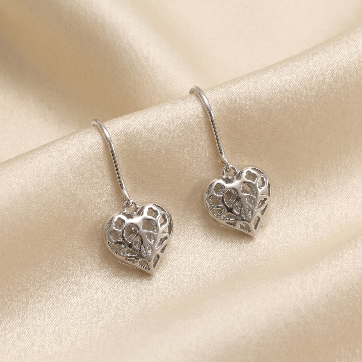Pair of sterling silver drop earrings featuring sculptural hanging hearts with delicate openwork inspired by Yorkshire, designed for refined everyday elegance.