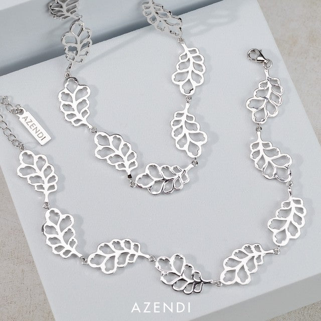 Linked sterling silver necklace featuring a series of openwork oak leaf motifs connected by delicate links, showcasing contemporary sculptural design.