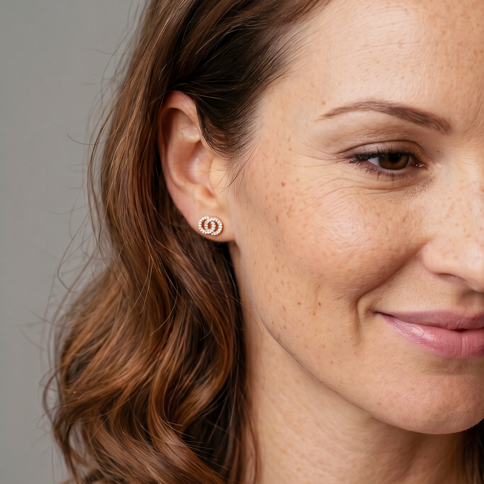 Pair of rose gold vermeil studs featuring interlocking circle motifs with a polished finish, offering a modern and elegant addition to sterling silver jewellery collections.