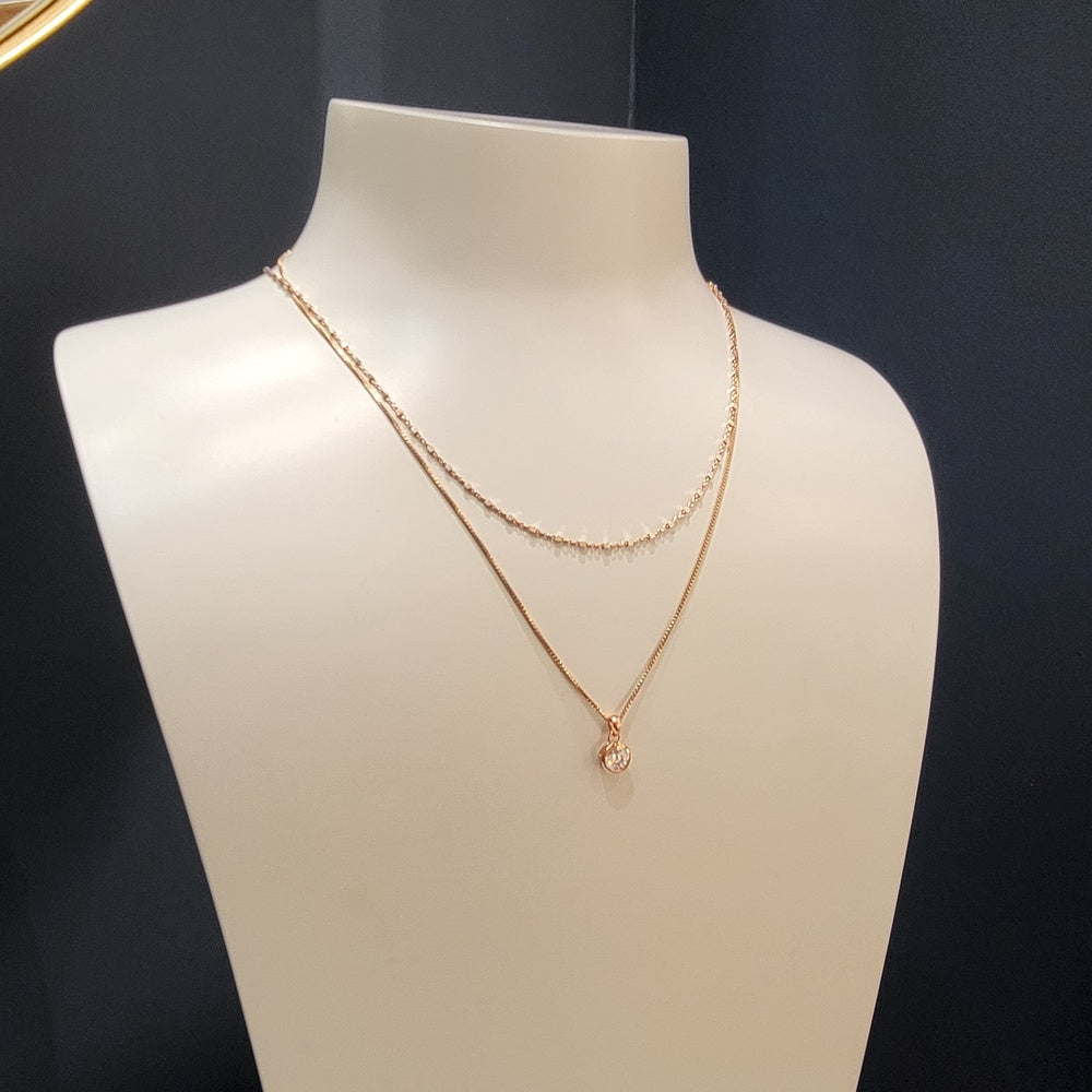 Delicate layering necklace featuring slender sterling silver chains adorned with small sculptural cubes, showcasing a contemporary design with refined geometric accents.