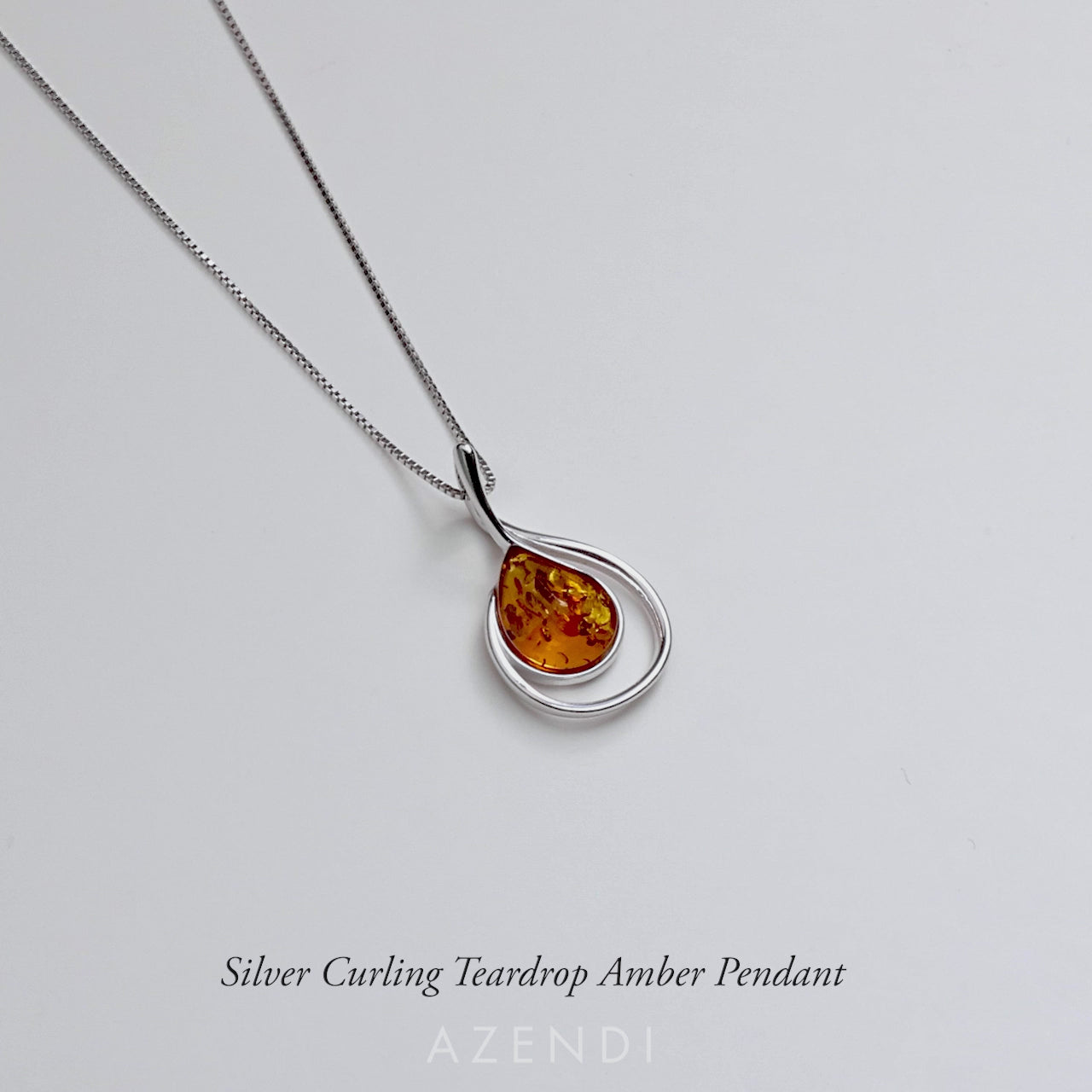 Silver Curling Teardrop Amber Pendant