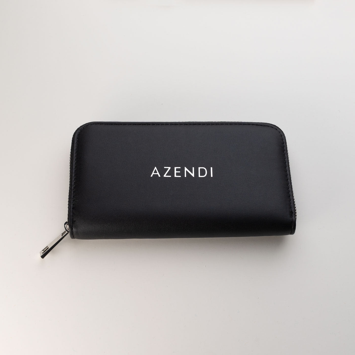 Black jewellery travel wallet crafted from PU leather with velvet and foam details, featuring a zip closure and the Azendi logo on the front.