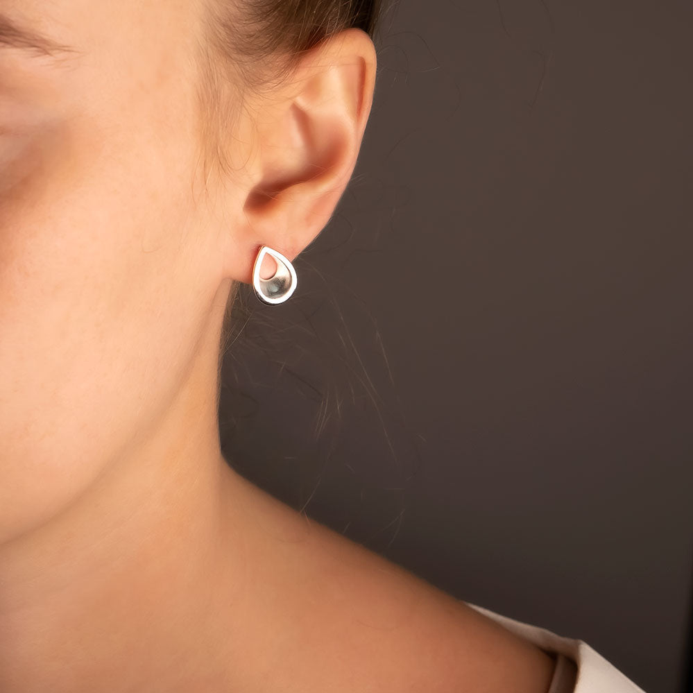 Sleek sterling silver teardrop studs featuring a minimalist open design, offering a refined and contemporary addition to any silver jewellery collection.