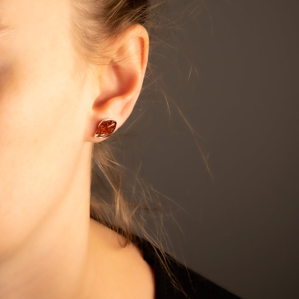 Sterling silver stud earrings featuring warm amber teardrop stones with a subtle twisted design, exemplifying refined British craftsmanship and contemporary elegance.