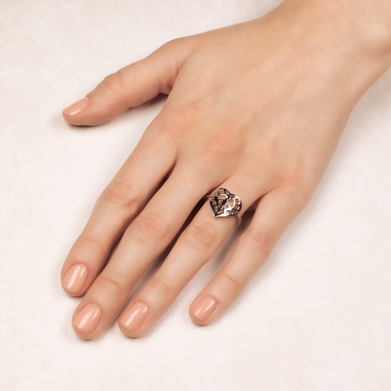 Sterling silver ring featuring a sculptural openwork heart inspired by Yorkshire, worn on a hand with a smooth band, showcasing expert British craftsmanship.