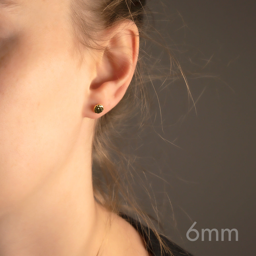Yellow gold vermeil stud earring with a subtle double curved, planished button design, offering a minimalist and sculptural accent to contemporary jewellery collections.