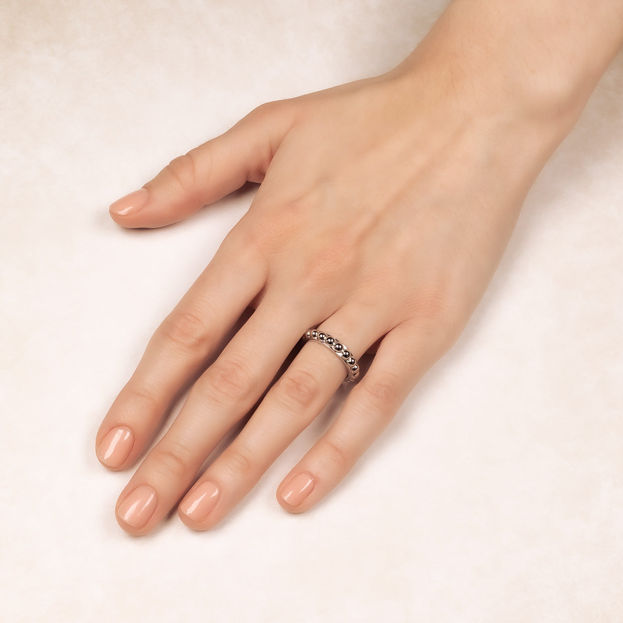 Sterling silver beaded band ring featuring a sculptural row of polished silver beads for a refined and contemporary sterling silver jewellery piece.