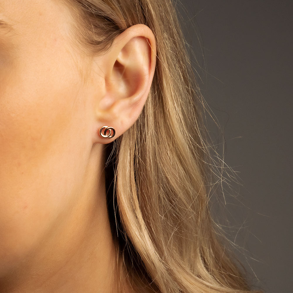Rose gold vermeil stud earrings featuring a sculptural interlocking design, offering a refined and contemporary addition to sterling silver jewellery collections.