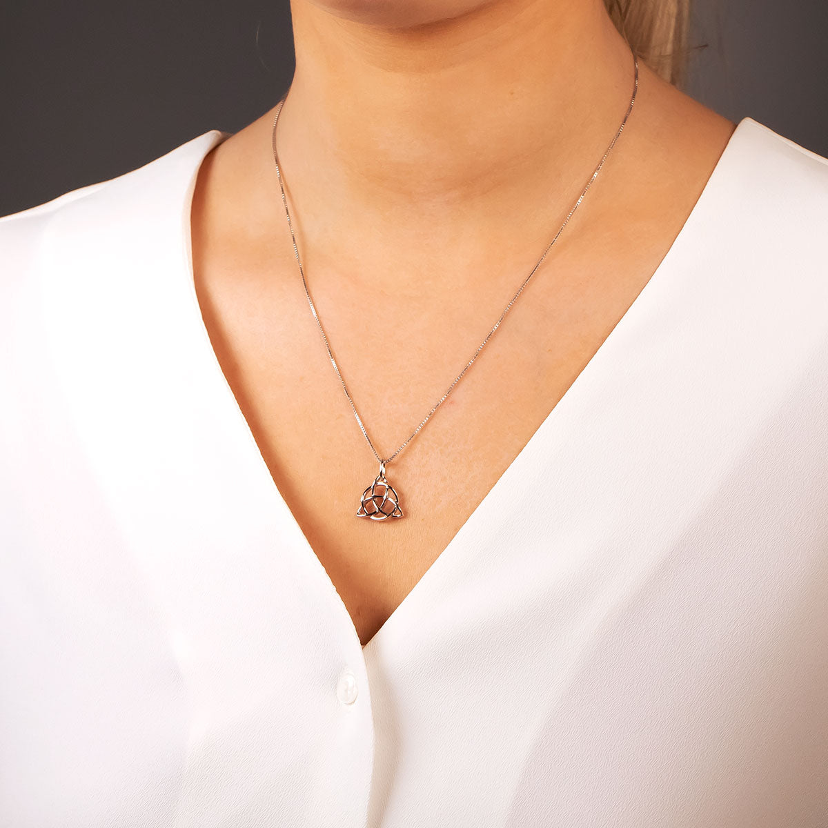 Sterling silver pendant featuring an intricate Celtic trinity knot design suspended from a fine chain, exemplifying elegant contemporary silver jewellery by Azendi.