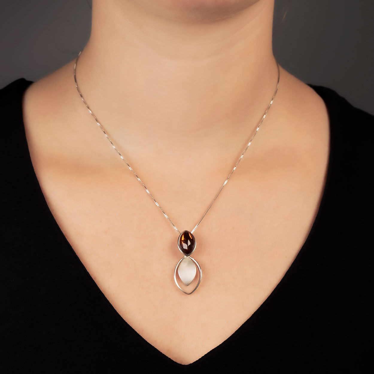 Sterling silver necklace featuring a sculptural double marquise design with an amber gemstone, showcasing refined British craftsmanship and elegant contemporary style.