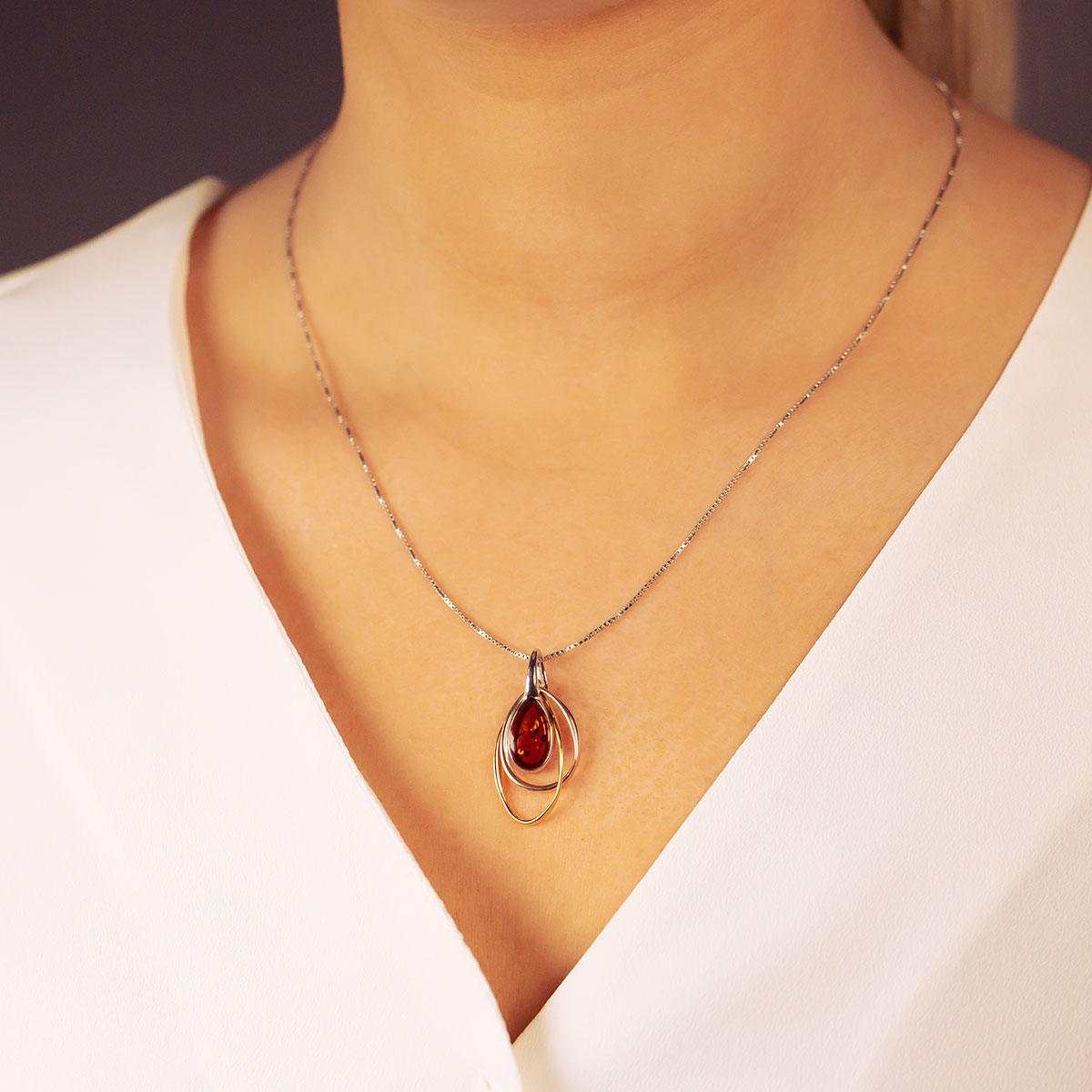 Sterling silver necklace featuring a sculptural three-color teardrop amber pendant, showcasing expert British craftsmanship with a modern, elegant design.