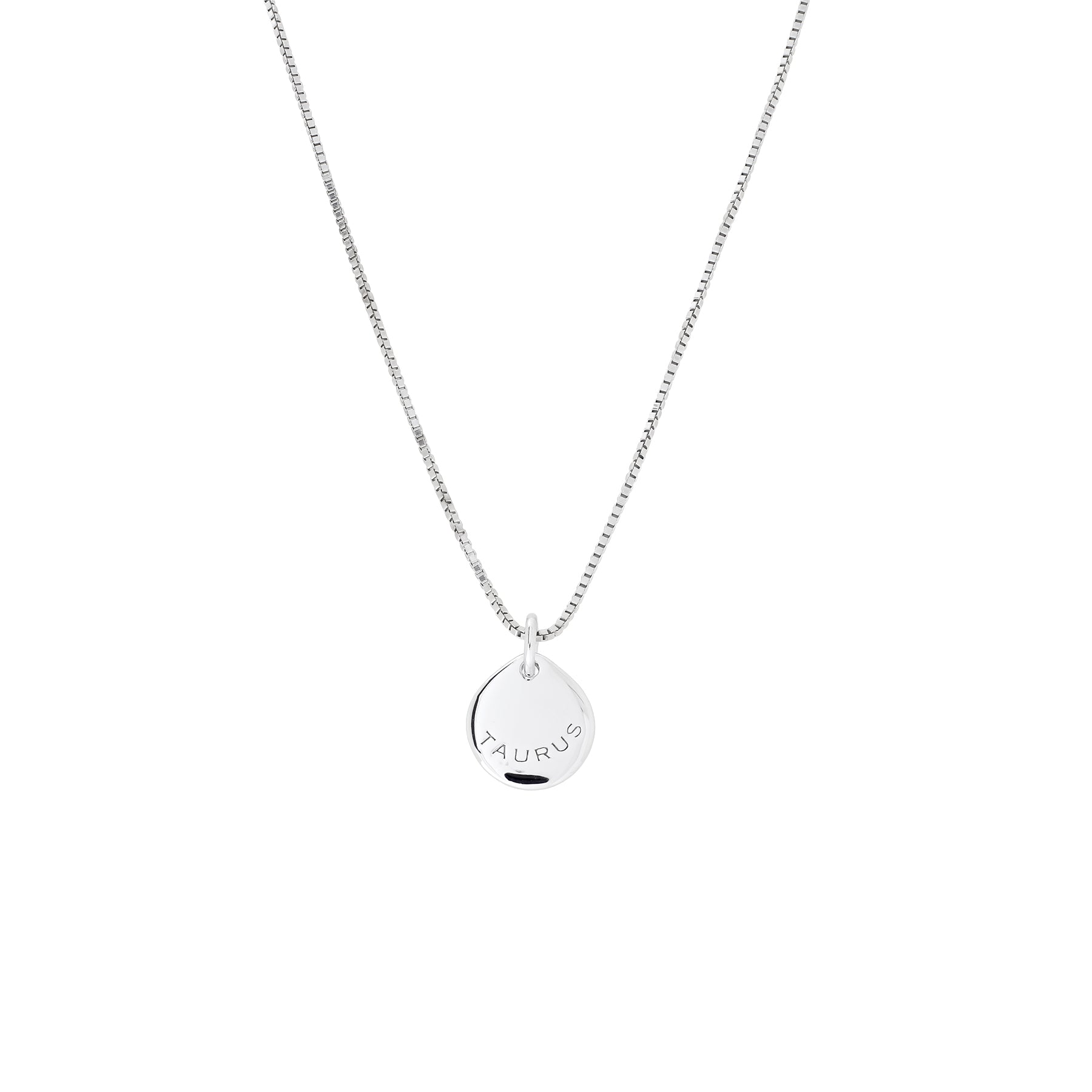Delicate sterling silver pendant necklace featuring a small round disc engraved with the Taurus zodiac sign, suspended from a fine chain against a white background.