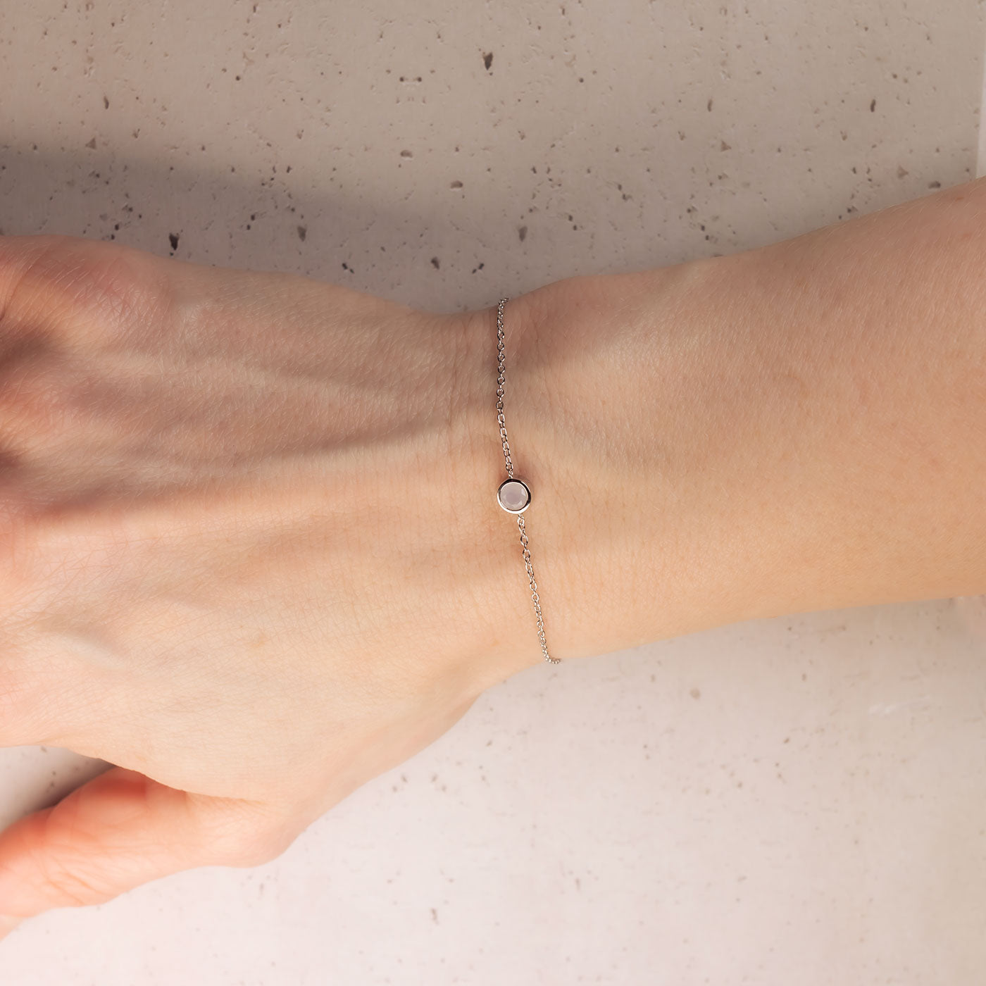 Delicate sterling silver bracelet featuring a small aqua chalcedony gemstone set on a fine adjustable chain, exemplifying refined British craftsmanship.