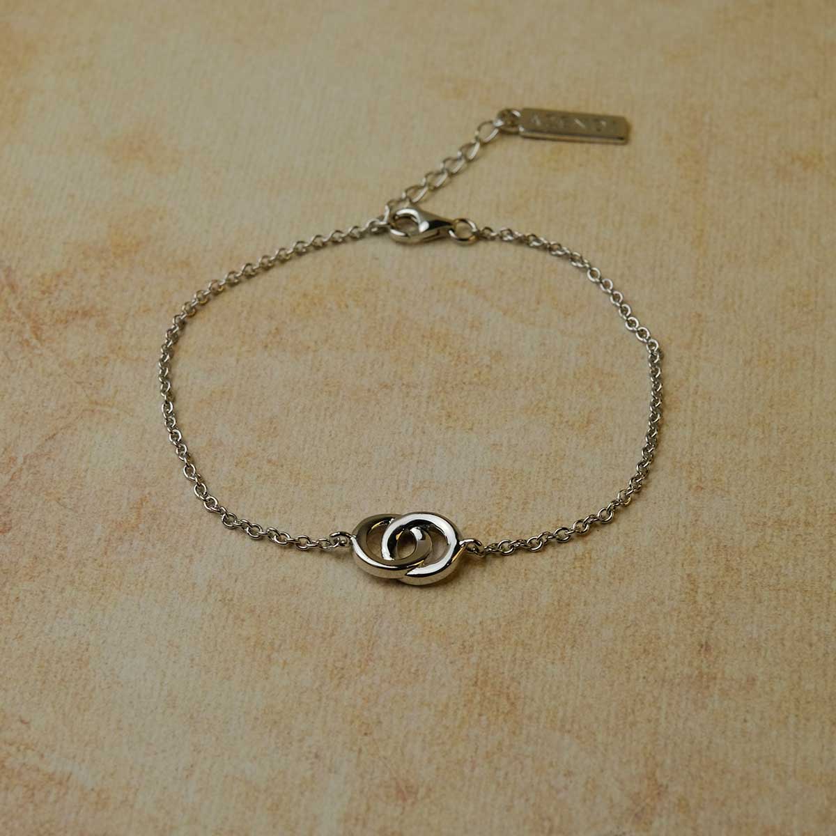 Delicate sterling silver bracelet featuring two interlocking circles on a fine chain with an adjustable extension, exemplifying elegant and contemporary Azendi silver jewellery design.