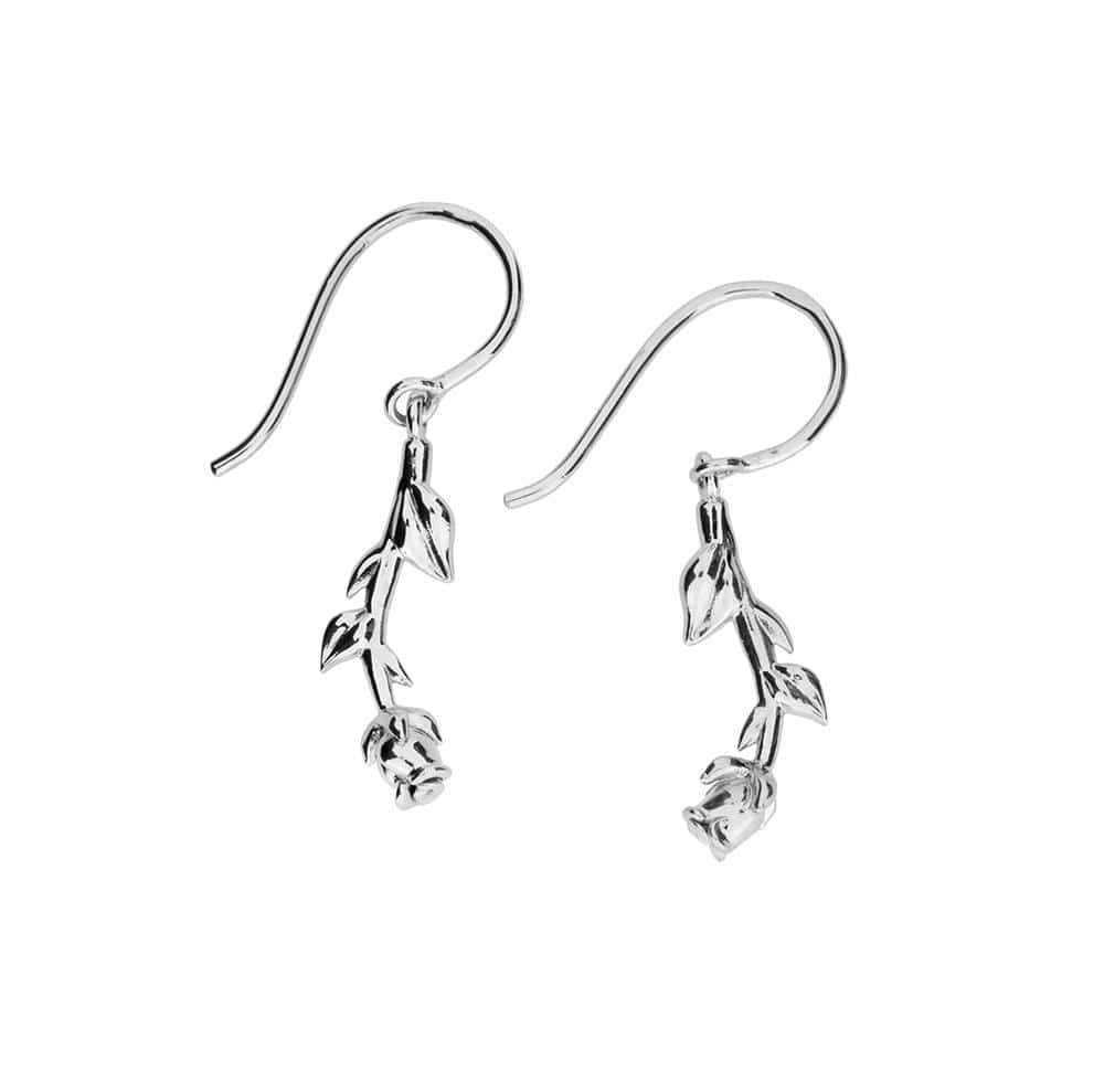 Delicate sterling silver earrings featuring sculptural rose and leaf motifs hanging from curved hooks, combining botanical elegance with fine British craftsmanship.